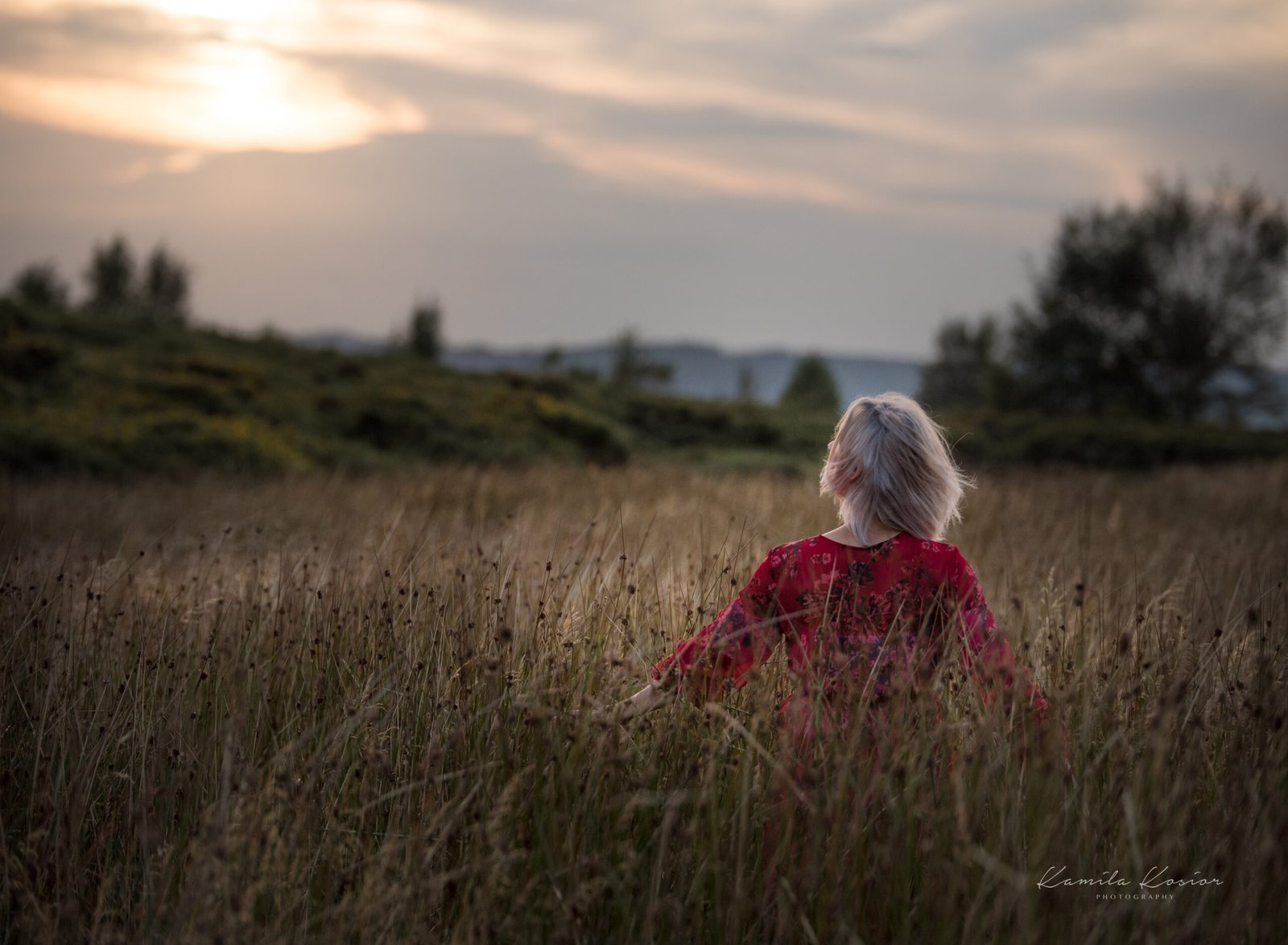 Monika in a meadow at dusk, photographed by Kamila Kosior